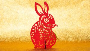 Chinese New Year of Rabbit mascot paper cut on golden background at horizontal composition no logo no trademark