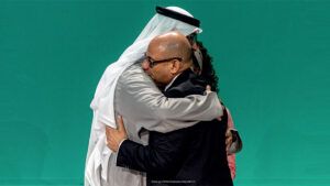 DECEMBER 13: H.E. Dr. Sultan Al Jaber, COP28 President (L) and Simon Stiell, Executive Secretary of the UNFCCC embrace onstage during the Closing Plenary at the UN Climate Change Conference COP28 at Expo City Dubai on December 13, 2023, in Dubai, United Arab Emirates. (Photo by COP28 / Christopher Pike)